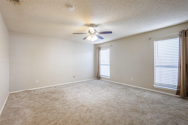 carpeted empty room featuring a textured ceiling and ceiling fan