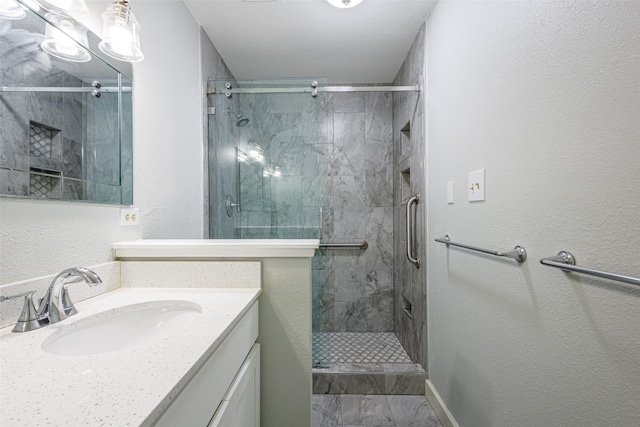 bathroom with vanity and a shower with door