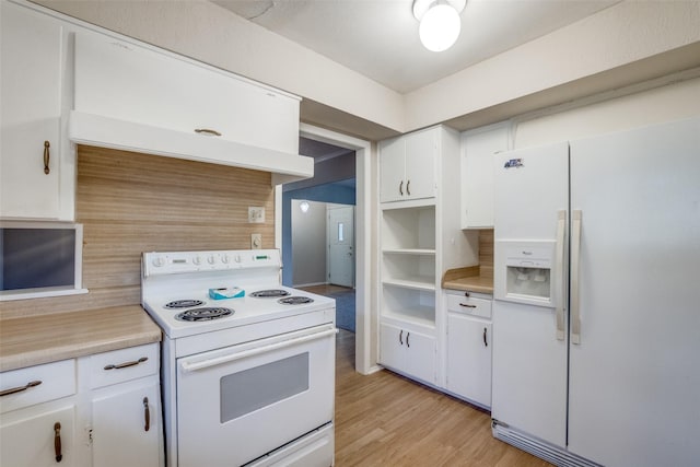 kitchen with white appliances, light hardwood / wood-style floors, and white cabinets