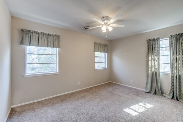 unfurnished room featuring ceiling fan and light carpet