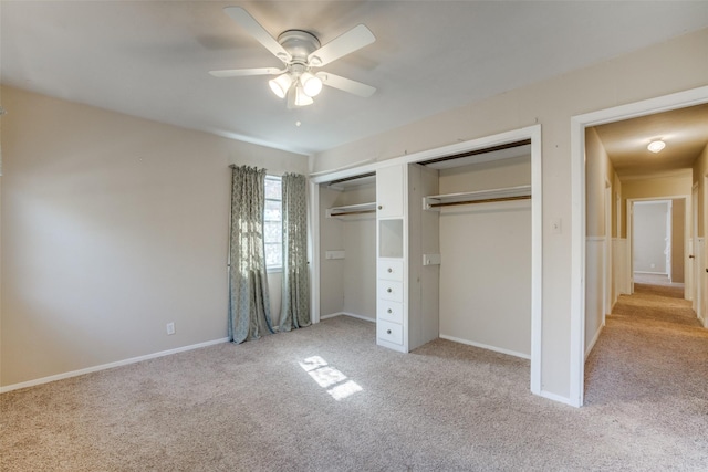 unfurnished bedroom featuring light colored carpet, a closet, and ceiling fan