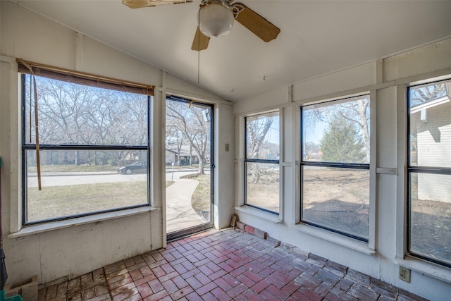 unfurnished sunroom with vaulted ceiling, ceiling fan, and plenty of natural light