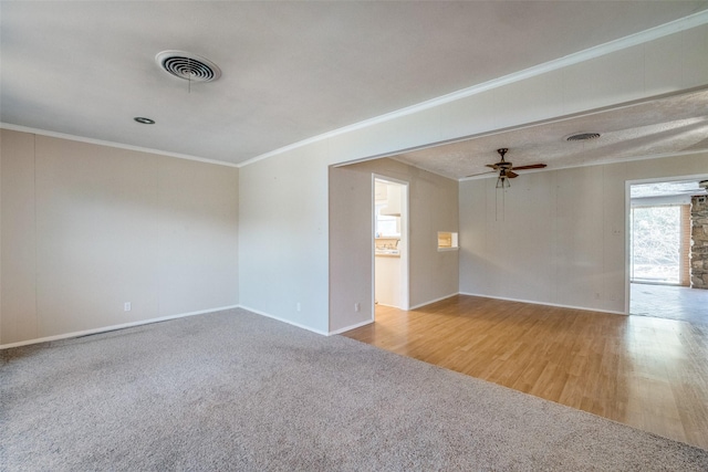 spare room with ornamental molding, light colored carpet, and ceiling fan