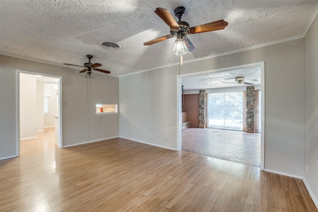 unfurnished room featuring ceiling fan, crown molding, light hardwood / wood-style flooring, and a textured ceiling