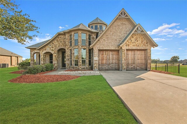 view of front of house with a garage and a front lawn