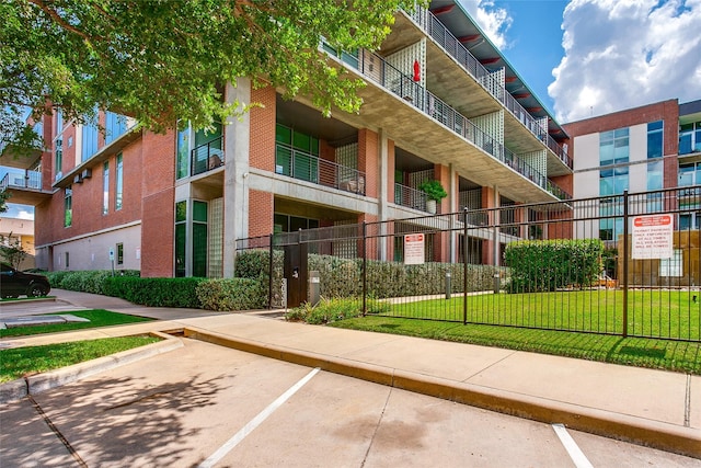 view of property with uncovered parking and fence