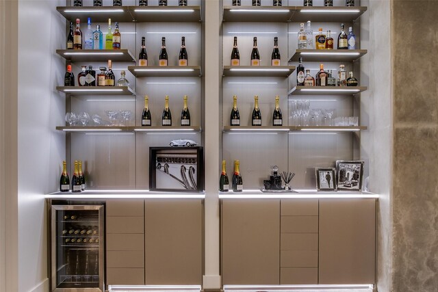 kitchen with a large island, sink, a breakfast bar area, beverage cooler, and black appliances