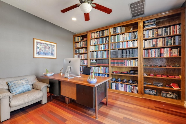 home office with hardwood / wood-style flooring and ceiling fan