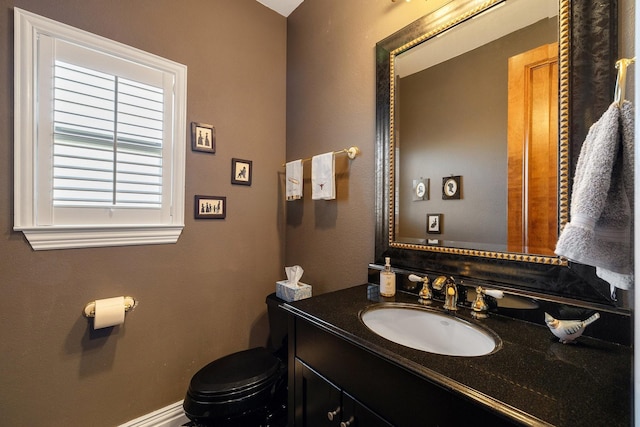 bathroom featuring vanity and toilet