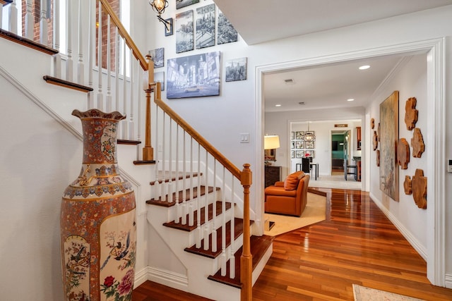 stairs featuring hardwood / wood-style floors