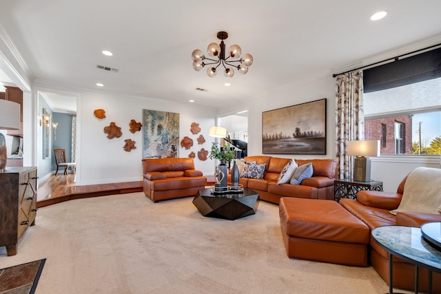 living room featuring an inviting chandelier and crown molding