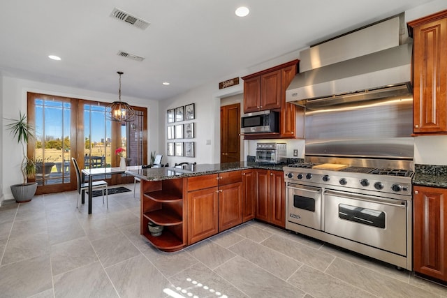 kitchen featuring wall chimney exhaust hood, appliances with stainless steel finishes, kitchen peninsula, and hanging light fixtures