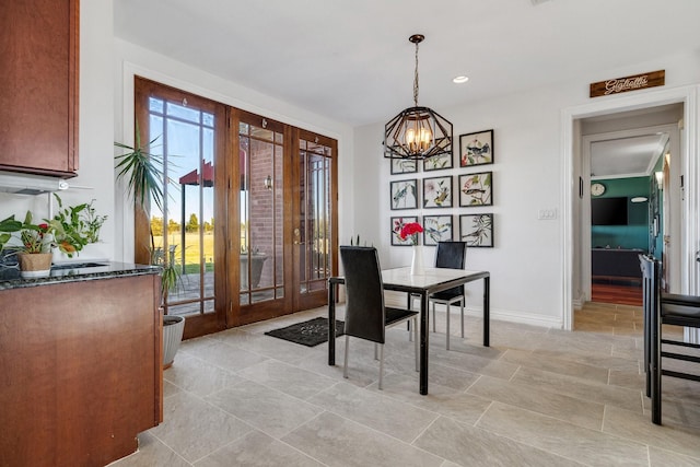 dining space with a notable chandelier and french doors