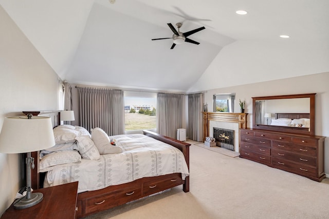 bedroom featuring lofted ceiling, light colored carpet, and ceiling fan