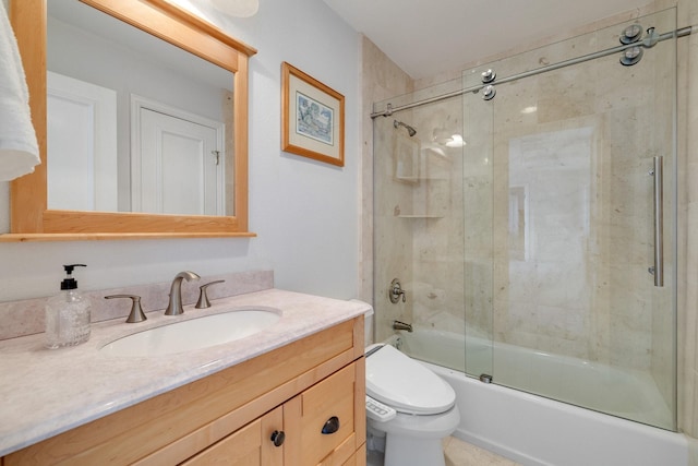 full bathroom with enclosed tub / shower combo, vanity, and toilet