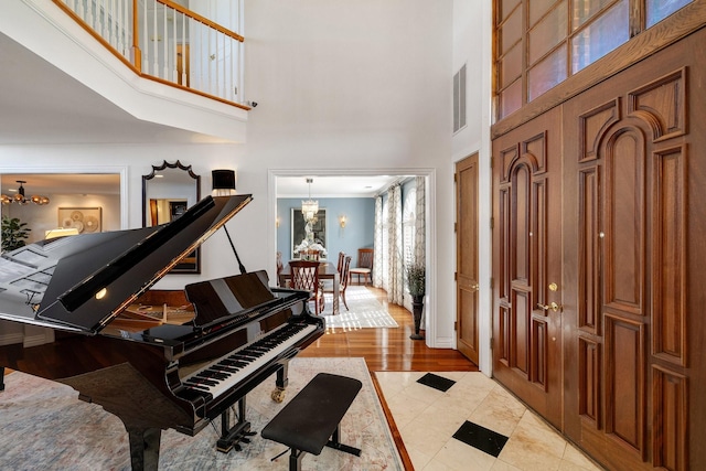 entrance foyer with a high ceiling and a notable chandelier