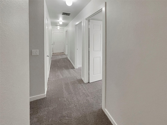 hallway with dark carpet