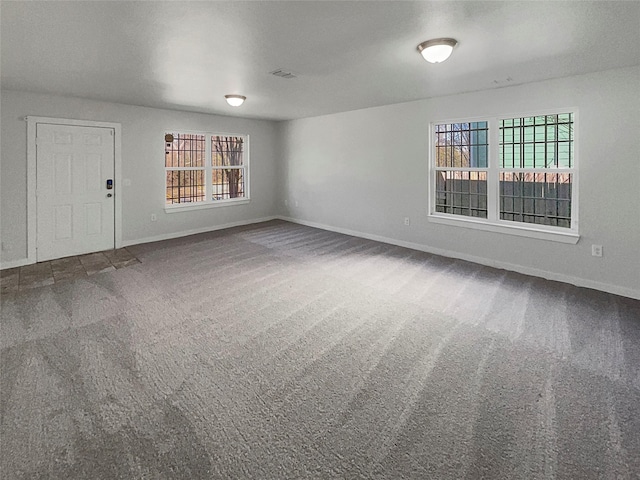 carpeted spare room with a healthy amount of sunlight