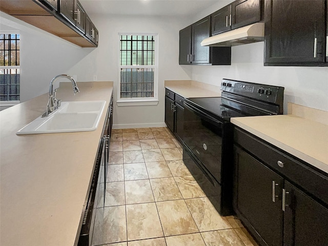 kitchen featuring dishwashing machine, black / electric stove, light tile patterned floors, and sink