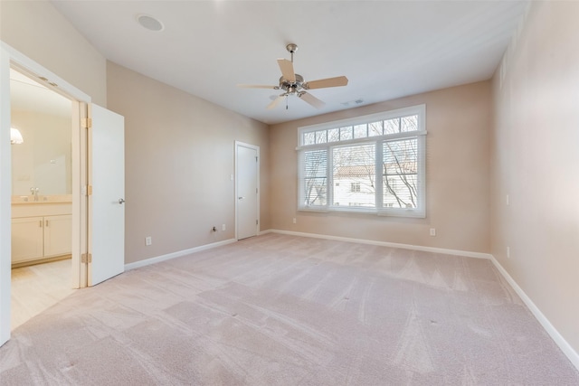 carpeted empty room with sink and ceiling fan