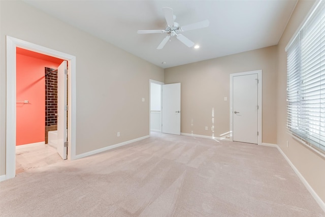 unfurnished bedroom featuring light carpet and ceiling fan