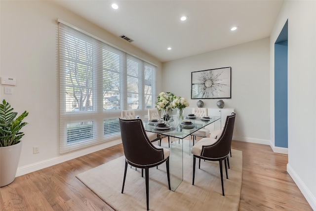 dining space with light hardwood / wood-style floors