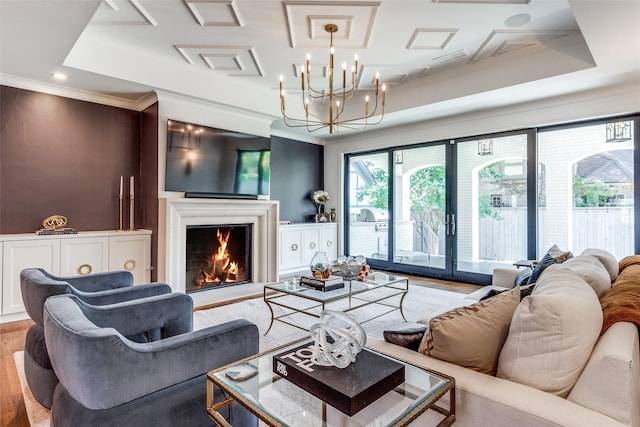 living room with wood-type flooring, a notable chandelier, a raised ceiling, crown molding, and french doors