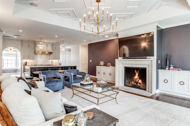 living room featuring ornamental molding and light hardwood / wood-style floors