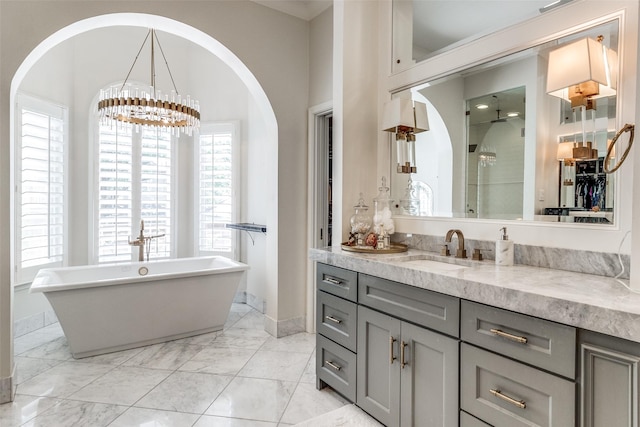 bathroom featuring vanity, plus walk in shower, and a notable chandelier