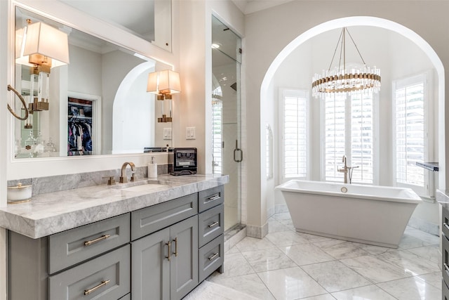 bathroom featuring vanity, ornamental molding, a chandelier, and plus walk in shower