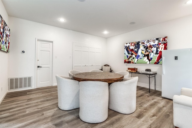 dining room with hardwood / wood-style flooring