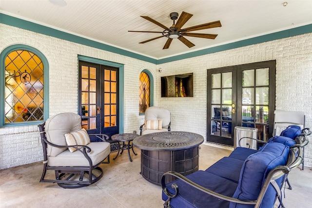 view of patio featuring a fire pit, ceiling fan, and french doors