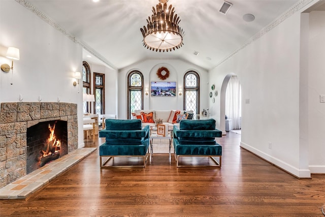 living room with lofted ceiling, a fireplace, and hardwood / wood-style floors