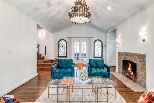 living room featuring lofted ceiling, dark hardwood / wood-style floors, a fireplace, and french doors