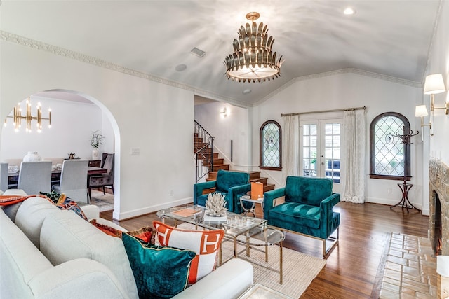 living room featuring french doors, lofted ceiling, crown molding, dark hardwood / wood-style floors, and a notable chandelier