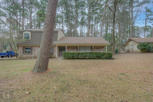 tri-level home with a front yard