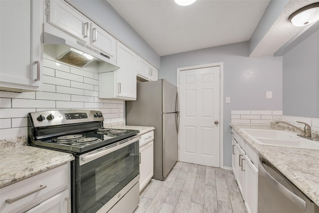 kitchen featuring white cabinetry, stainless steel appliances, sink, and decorative backsplash