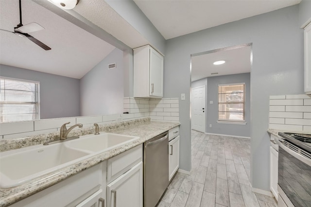 kitchen featuring white cabinetry, appliances with stainless steel finishes, sink, and plenty of natural light