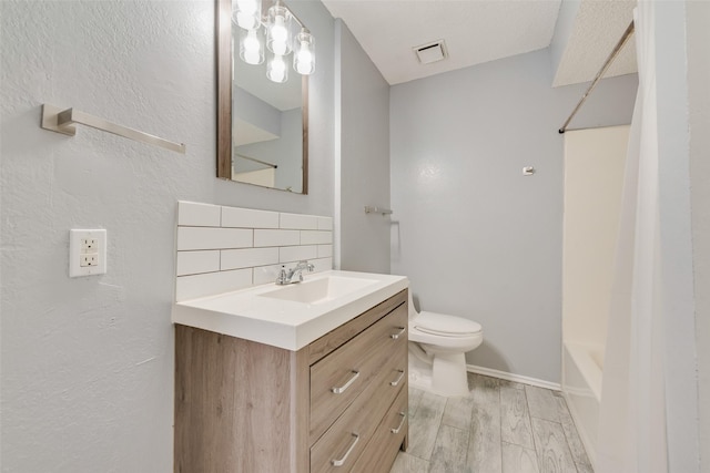 full bathroom featuring tasteful backsplash, vanity, shower / bathtub combination, and toilet