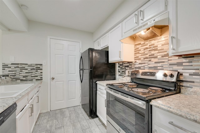 kitchen featuring appliances with stainless steel finishes, tasteful backsplash, white cabinetry, sink, and light stone countertops