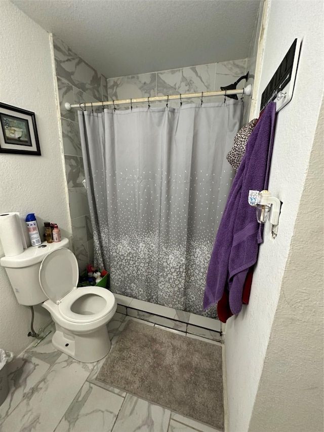 bathroom with toilet, a textured ceiling, and walk in shower