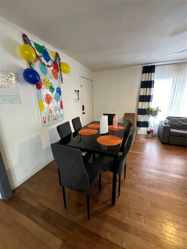 dining room with wood-type flooring