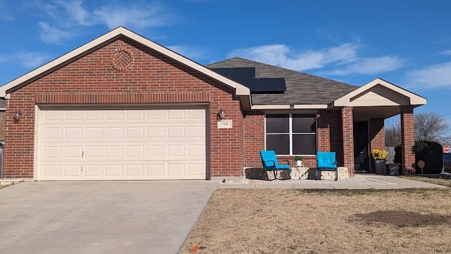 view of front of home with a garage and solar panels