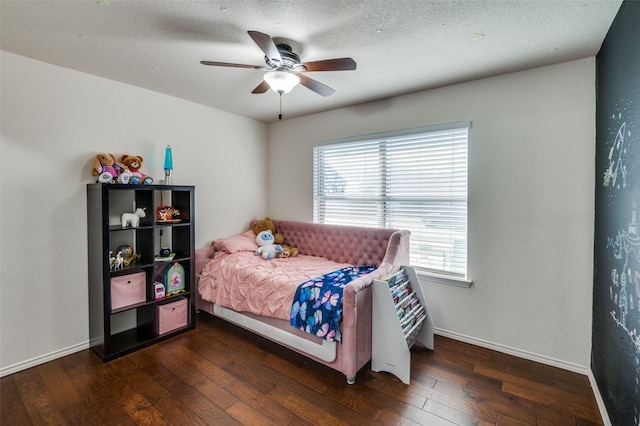 bedroom with dark hardwood / wood-style floors, a textured ceiling, and ceiling fan