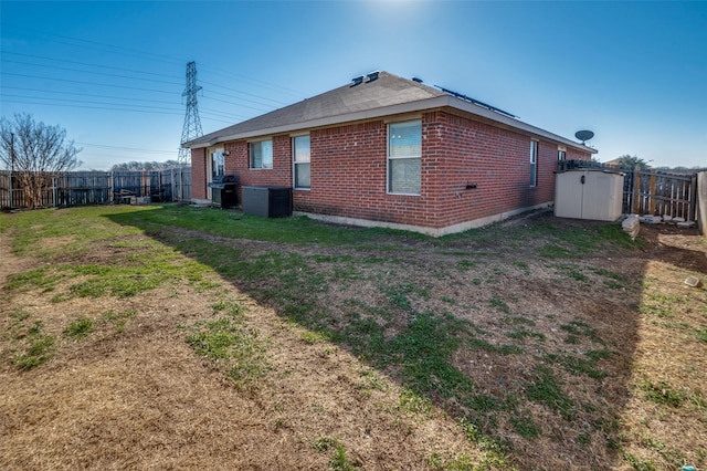 view of property exterior featuring a lawn and a storage unit