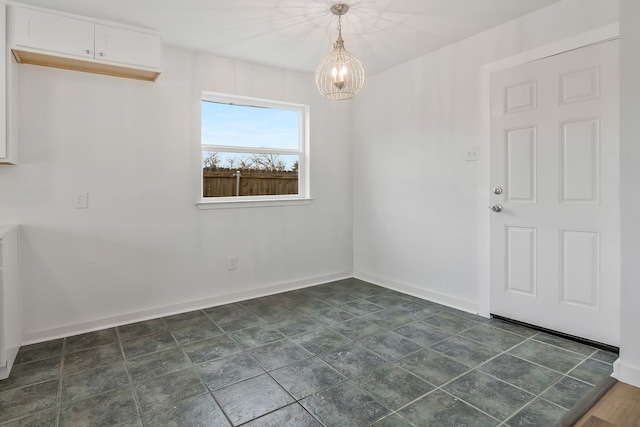 unfurnished dining area featuring a notable chandelier