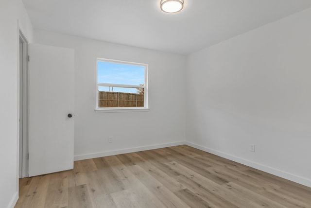 unfurnished room with light wood-type flooring