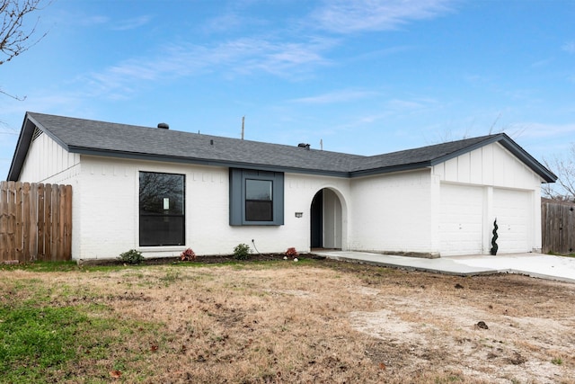 single story home with a garage and a front yard