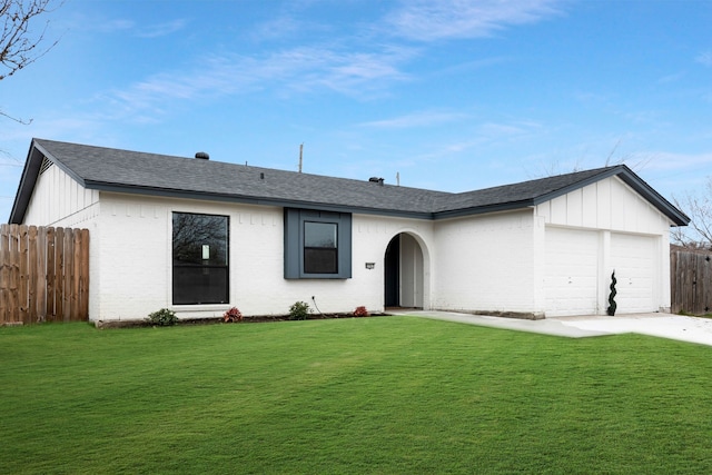 ranch-style home featuring brick siding, a front lawn, an attached garage, and fence