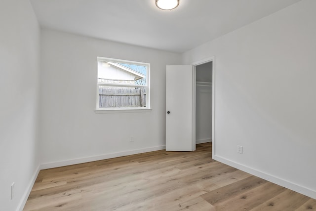 unfurnished bedroom featuring light wood-type flooring and a closet